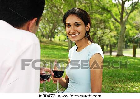 Couple holding wine glasses, woman looking at camera View Large Photo Image Stock Image - Couple holding wine glasses, woman looking at camera. Fotosearch