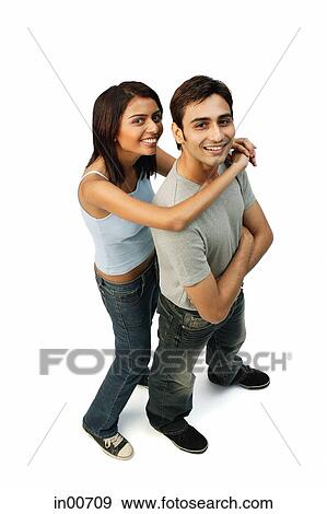 Couple looking at camera, woman hugging man from behind View Large Photo Image Stock Photo - Couple looking at camera, woman hugging man from behind. Fotosearch