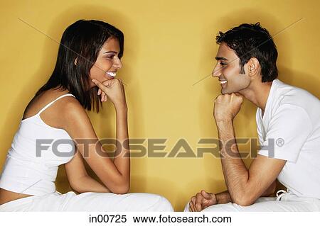 Couple sitting face to face, hands on chin View Large Photo Image Stock Photography - Couple sitting face to face, hands on chin. Fotosearch
