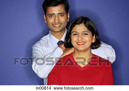 Couple smiling at camera, man behind woman View Large Photo Image Picture - Couple smiling at camera, man behind woman. Fotosearch