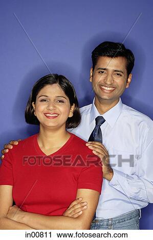 Stock Image - Couple smiling at camera, portrait. Fotosearch