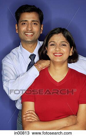 Stock Image - Couple smiling at camera, portrait. Fotosearch