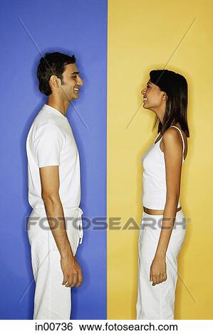 Stock Photograph - Couple standing apart, face to face, side view. Fotosearch