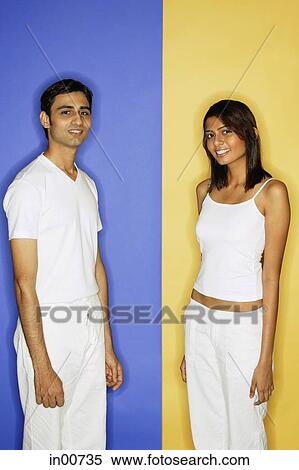 Stock Photography - Couple standing apart, looking at camera. Fotosearch