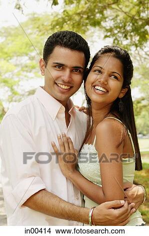 Couple standing cheek to cheek, man looking at camera View Large Photo Image Picture - Couple standing cheek to cheek, man looking at camera. Fotosearch