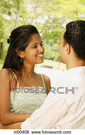 Couple standing, looking at each other, portrait View Large Photo Image Stock Photo - Couple standing, looking at each other, portrait. Fotosearch