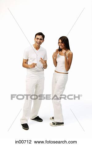 Couple standing side by side, smiling, making fists View Large Photo Image Stock Image - Couple standing side by side, smiling, making fists. Fotosearch