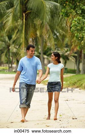Couple walking on beach, holding hands View Large Photo Image Stock Photography - Couple walking on beach, holding hands. Fotosearch