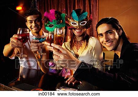 Picture - Couples at bar, holding drinks, looking at camera. Fotosearch