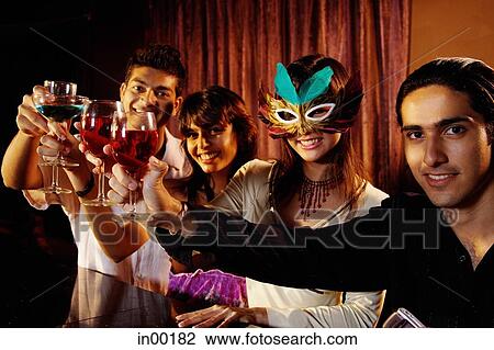 Couples at bar, toasting, looking at camera View Large Photo Image Stock Image - Couples at bar, toasting, looking at camera. Fotosearch