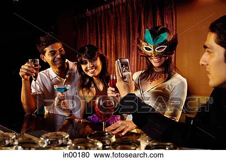 Couples at bar, with drinks and mobile phone. View Large Photo Image Stock Image - Couples at bar, with drinks and mobile phone.. Fotosearch