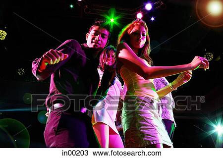 Couples dancing in club, looking at camera View Large Photo Image Stock Image - Couples dancing in club, looking at camera. Fotosearch