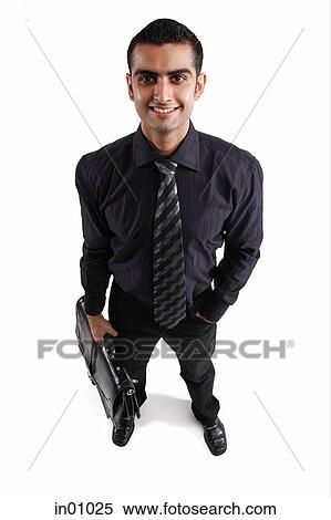 Stock Photography - Executive carrying briefcase, hand in pocket. Fotosearch