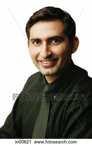 Stock Image - Executive looking at camera, smiling. Fotosearch