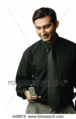 Executive looking down at mobile phone View Large Photo Image Stock Photography - Executive looking down at mobile phone. Fotosearch