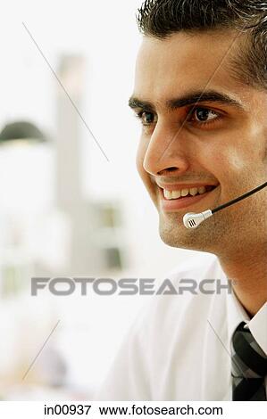 Executive using headset, smiling, head shot View Large Photo Image Stock Photo - Executive using headset, smiling, head shot. Fotosearch