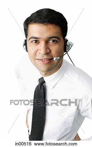 Stock Photograph - Executive wearing headset, looking at camera. Fotosearch