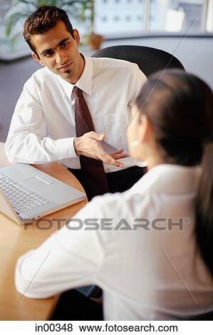 Executives having a meeting, high angle view View Large Photo Image Stock Photo - Executives having a meeting, high angle view. Fotosearch