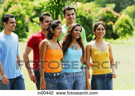 Group of friends walking in park View Large Photo Image Stock Image - Group of friends walking in park. Fotosearch