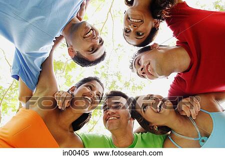 Group of young adults arms around each other, smiling at each other View Large Photo Image Stock Photography - Group of young adults arms around each other, smiling at each other. Fotosearch