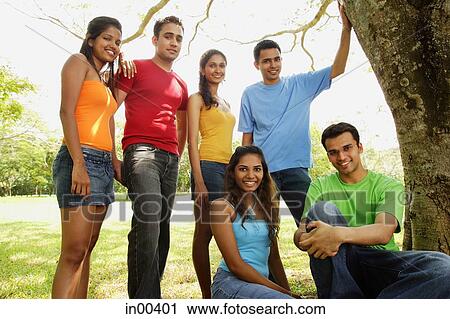 Group of young adults in park, looking at camera, portrait View Large Photo Image Stock Image - Group of young adults in park, looking at camera, portrait. Fotosearch