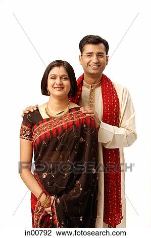 Indian couple in traditional clothing, looking at camera View Large Photo Image Stock Image - Indian couple in traditional clothing, looking at camera. Fotosearch