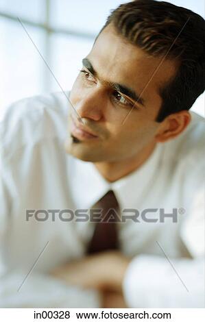 Stock Photo - Male executive, looking away, portrait. Fotosearch