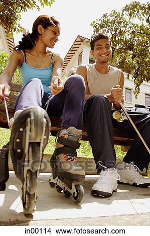 Man and woman lacing up roller blades View Large Photo Image Picture - Man and woman lacing up roller blades. Fotosearch