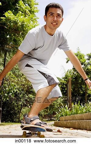 Man balancing on skateboard, looking away View Large Photo Image Stock Photo - Man balancing on skateboard, looking away. Fotosearch