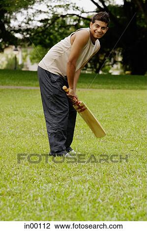 Man holding cricket bat View Large Photo Image Stock Image - Man holding cricket bat. Fotosearch