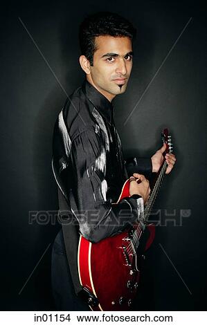 Picture - Man holding guitar. Fotosearch