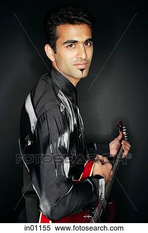 Man holding guitar, portrait View Large Photo Image Stock Photography - Man holding guitar, portrait. Fotosearch