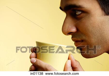 Stock Photo - Man holding mug, profile. Fotosearch