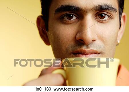 Man holding mug to mouth View Large Photo Image Stock Photo - Man holding mug to mouth. Fotosearch