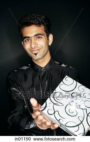 Man holding present View Large Photo Image Stock Image - Man holding present. Fotosearch