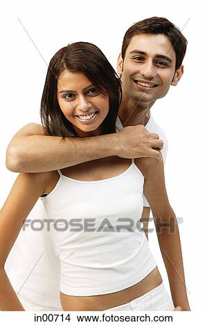 Man hugging woman from behind, both looking at camera View Large Photo Image Picture - Man hugging woman from behind, both looking at camera. Fotosearch