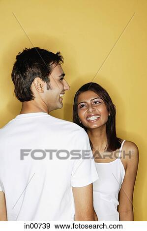 Man in front of woman, both smiling View Large Photo Image Stock Photo - Man in front of woman, both smiling. Fotosearch