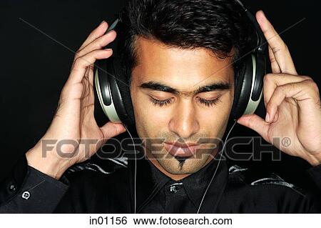 Man listening to music with headphones View Large Photo Image Stock Photograph - Man listening to music with headphones. Fotosearch