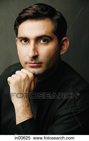 Man looking at camera, hand on chin, portrait View Large Photo Image Stock Photography - Man looking at camera, hand on chin, portrait. Fotosearch