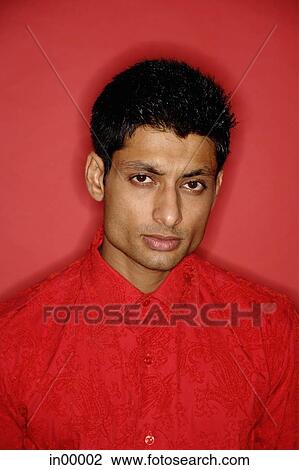 Stock Image - Man looking at camera, serious expression. Fotosearch