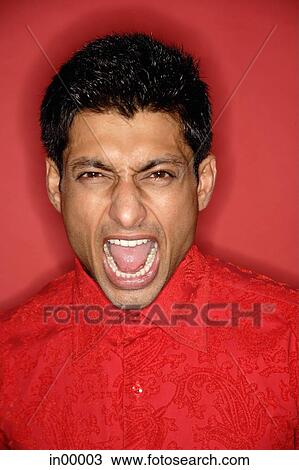 Stock Image - Man looking at camera, shouting. Fotosearch