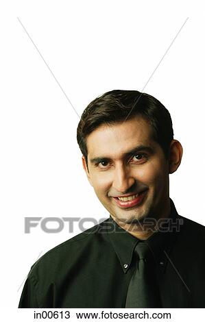 Stock Image - Man looking at camera, smiling. Fotosearch