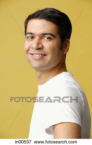 Stock Photo - Man looking at camera, smiling. Fotosearch