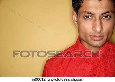Man looking at camera, yellow background View Large Photo Image Stock Image - Man looking at camera, yellow background. Fotosearch