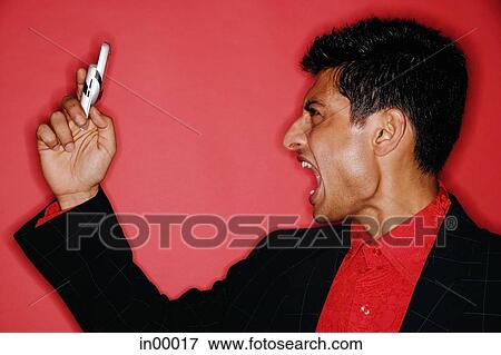 Man looking at handphone, mouth open, shouting View Large Photo Image Stock Photo - Man looking at handphone, mouth open, shouting. Fotosearch