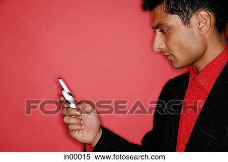 Man looking at handphone, sideview View Large Photo Image Stock Photography - Man looking at handphone, sideview. Fotosearch