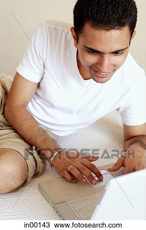 Man looking at laptop View Large Photo Image Stock Image - Man looking at laptop. Fotosearch