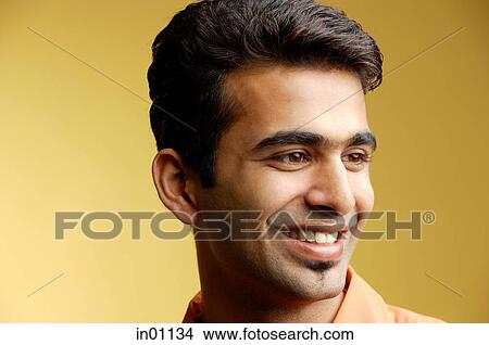 Man looking away, smiling View Large Photo Image Picture - Man looking away, smiling. Fotosearch