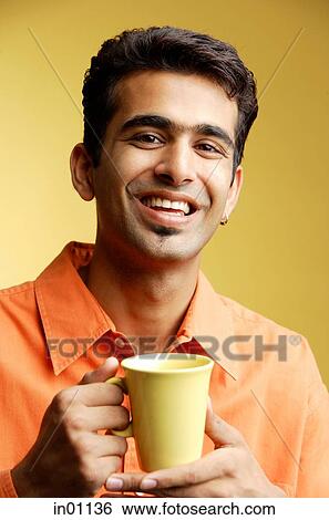 Man smiling at camera, mug in hand View Large Photo Image Stock Photograph - Man smiling at camera, mug in hand. Fotosearch