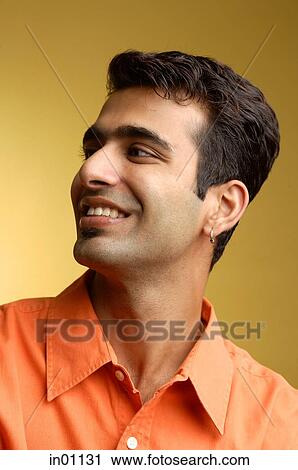 Stock Image - Man smiling, looking away, head shot. Fotosearch